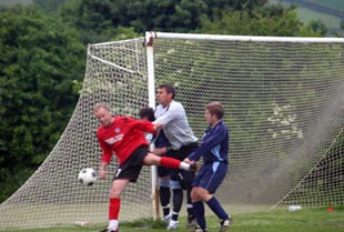 Ricky Drury receives strong attention during Weald of Kent Charity Cup Final